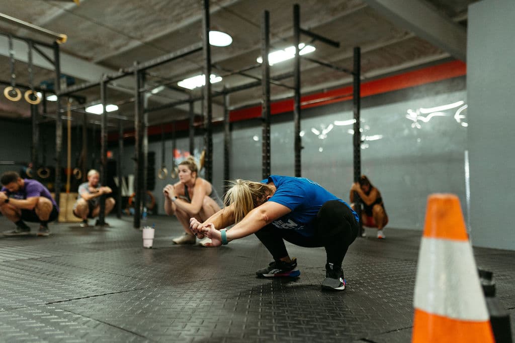 CrossFit athletes practicing the air squat