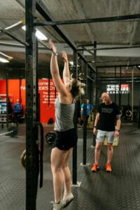A CrossFit athlete prepares to do a pull up